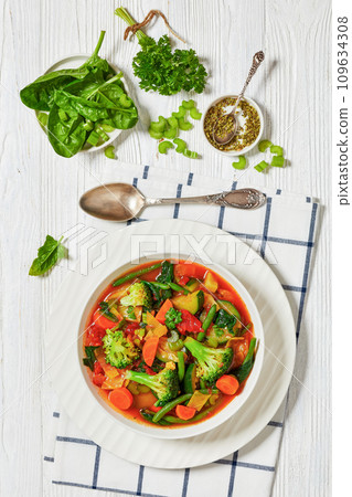 vegetable soup with green beans, broccoli, carrot, celery, spinach, cabbage, onion, tomatoes  109634308