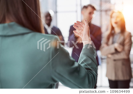 executive manager employer introducing welcoming newcomer to workmates. 109634499