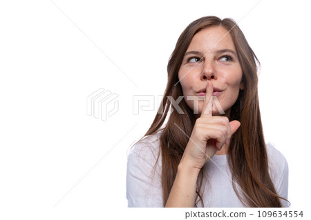 Young woman keeping a secret and covering her mouth with her finger Young woman keeping a secret and covering her mouth with her finger 109634554