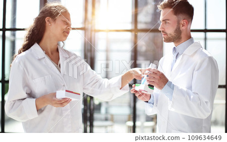 doctor's look at pills in bottle, prescription reading and contents. healthcare self-healing concept. 109634649