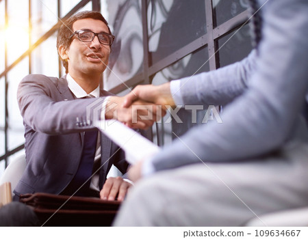 Shot of businessmen making a deal after viewing a document 109634667