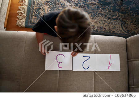 A boy with autism puts numbers in order. 109634866