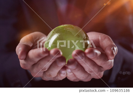 man holding a small green glass ball, generative ai 109635186