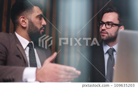 Business man talking with his colleague in the office at the table Business man talking with his colleague in the office at the table 109635203