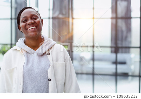 Smiling young woman standing and looking at the camera. Smiling young woman standing and looking at the camera. 109635212