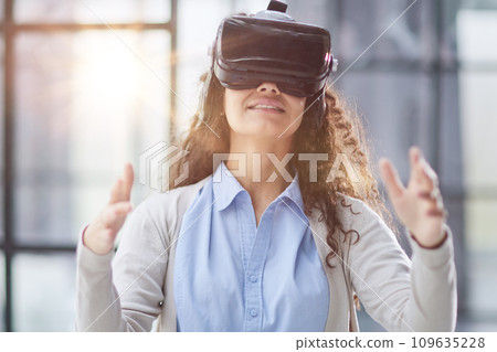 positive woman wearing virtual reality goggles headsetConnection, technology, new generation, progress concept. positive woman wearing virtual reality goggles headsetConnection, technology, new generation, progress concept. 109635228