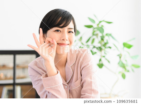 A woman in her 20s weighing herself A woman in her 20s weighing herself 109635681