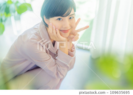 A woman in her 20s weighing herself 109635695
