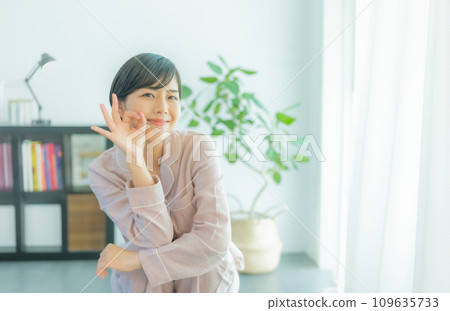 A woman in her 20s weighing herself A woman in her 20s weighing herself 109635733