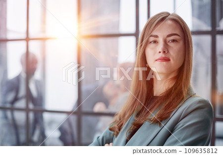 Portrait of a confident young businesswoman standing with her arms crossed in an office 109635812