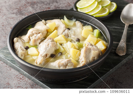 Chicken souse is a Bahamian soup consisting of clear broth where the meat and the vegetables are boiled down in the juice of fresh citrus closeup on the plate. Horizontal Chicken souse is a Bahamian soup consisting of clear broth where the meat and the vegetables are boiled down in the juice of fresh citrus closeup on the plate. Horizontal 109636011