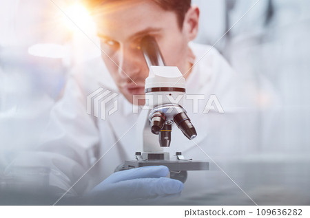 close up. the scientist looks through the microscope close up. the scientist looks through the microscope 109636282