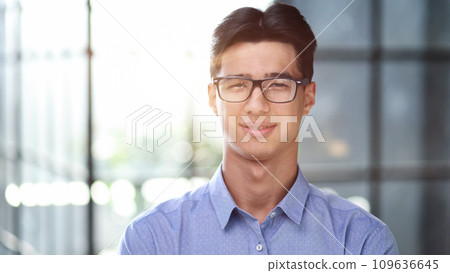 Portrait of a successful Asian businessman, in a modern office b Portrait of a successful Asian businessman, in a modern office b 109636645