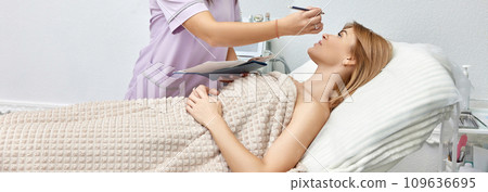 cosmetologist marking skin of caucasian woman with white pencil. facial marking for aesthetic procedure. cosmetologist marking skin of caucasian woman with white pencil. facial marking for aesthetic procedure. 109636695
