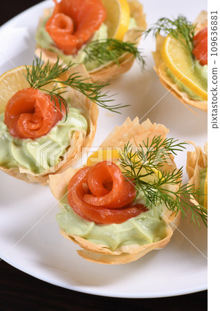 Filo dough baskets with avocado pate and salmon Filo dough baskets with avocado pate and salmon 109636881