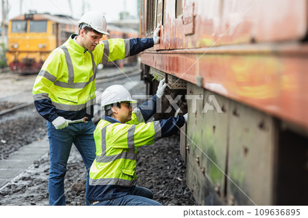 engineer team service maintenance old broken diesel train park at railway depot team working with safety suit. 109636895