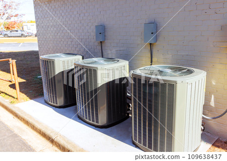 An outdoor air conditioning units has been installed on exterior facade of new house 109638437