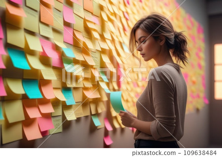 A woman standing in front of a wall full of colorful sticky notes. Young woman working in office and use post it notes to share idea. Communicating together in creative office. Brainstorming concept. 109638484
