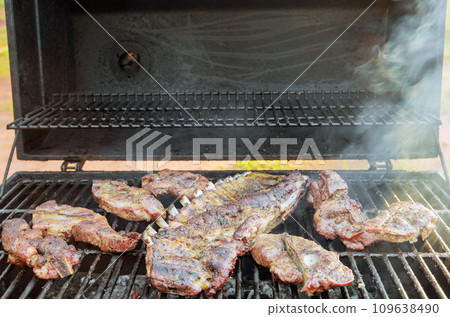 BBQ grill is used to hot smoke variety of juicy pork meats BBQ grill is used to hot smoke variety of juicy pork meats 109638490