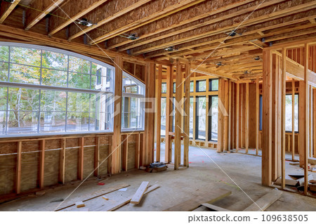 An new construction home with wooden framing beams attached to framework An new construction home with wooden framing beams attached to framework 109638505