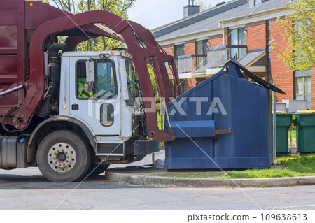 Municipal sanitation disposal service recycling garbage collector truck loading waste trash bin 109638613