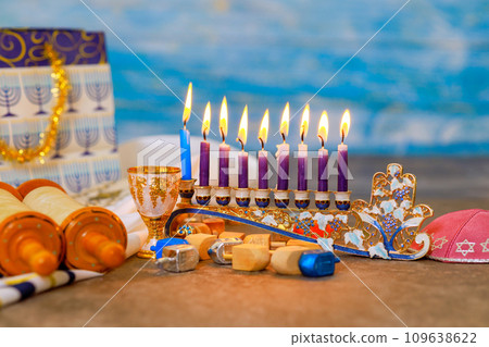 Jewish holiday symbol for Hanukkah is Hanukkiah Menorah with flame burning Jewish holiday symbol for Hanukkah is Hanukkiah Menorah with flame burning 109638622