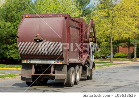 Service truck working on street sleeping area for suburban garbage disposal service 109638629
