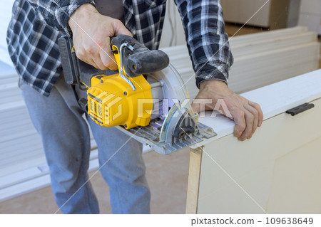In order to install interior doors, they must be cut to desired size using manual circular saw In order to install interior doors, they must be cut to desired size using manual circular saw 109638649