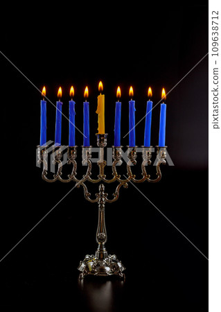 An representing Hanukkah, Jewish holiday associated with Hanukkiah menorah that burn candles An representing Hanukkah, Jewish holiday associated with Hanukkiah menorah that burn candles 109638712