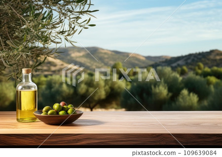 Old wooden product display table with natural green olive field and olive oil 109639084