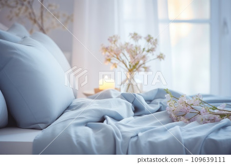 Cozy blue bedroom with flowers and candles. Bedroom with bed, pillow and duvet. Cozy blue bedroom with flowers and candles. Bedroom with bed, pillow and duvet. 109639111