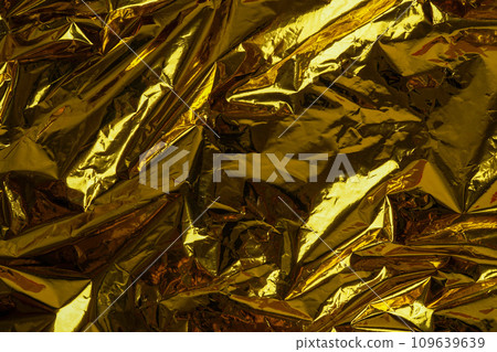 Crumpled foil texture background, close up golden foil 109639639