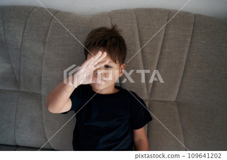 A boy with autism is stimming. A boy with autism is stimming. 109641202