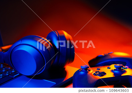 Headphones, joystick and computer keyboard on black table Headphones, joystick and computer keyboard on black table 109643603