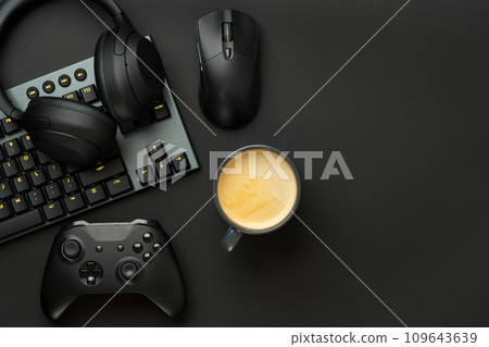 Gaming concept on black background with computer keyboard and joystick Gaming concept on black background with computer keyboard and joystick 109643639