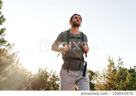 Portrait of hiker man with backpack trekking in the mountains Portrait of hiker man with backpack trekking in the mountains 109643879