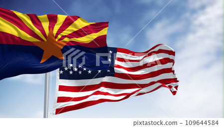 Flags of Arizona and United States waving in the wind on a clear day 109644584