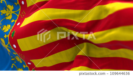 Valencian Community flag waving. Autonomous community of Spain. Four red bars on yellow, blue strip next to hoist. 3d illustration render. Selective focus. Close-up. Fluttering fabric 109644636