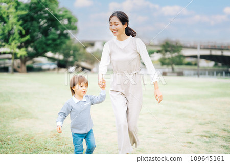 Parent and child holding hands for a walk 109645161