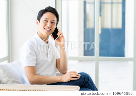 A man operating a smartphone. A man operating a smartphone. 109645893