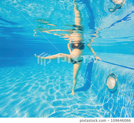 Embracing aquatic fitness, a pregnant woman demonstrates strength and serenity in underwater aerobics, creating a serene and empowering image in the pool Embracing aquatic fitness, a pregnant woman demonstrates strength and serenity in underwater aerobics, creating a serene and empowering image in the pool 109646066