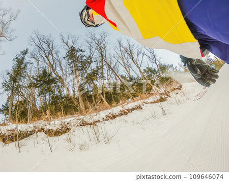 A daring man conquers snowy slopes with style, showcasing skill and thrill as he maneuvers on a snowboard, capturing the essence of winter adventure A daring man conquers snowy slopes with style, showcasing skill and thrill as he maneuvers on a snowboard, capturing the essence of winter adventure 109646074