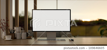 Home workspace with a computer mockup, keyboard, wireless mouse, and accessories on a wooden desk. 109646605