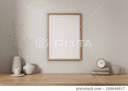 A minimalist wooden frame on a white wall and space on a wooden desk in a minimal, Scandinavian room A minimalist wooden frame on a white wall and space on a wooden desk in a minimal, Scandinavian room 109646617