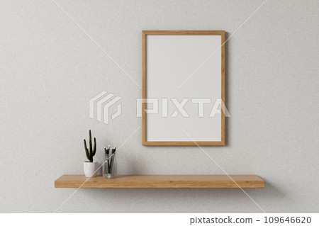 Front view of a minimalist wooden picture frame on a white wall in a minimal, Scandinavian room. 109646620