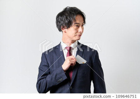A man takes out a credit card from his chest pocket A man takes out a credit card from his chest pocket 109646751