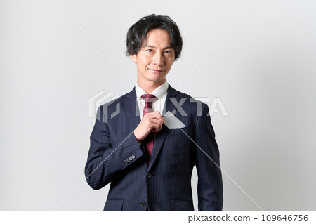 A man takes out a credit card from his chest pocket A man takes out a credit card from his chest pocket 109646756