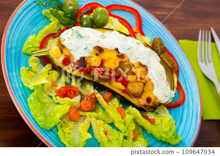 Tasty eggplant stuffed with vegetables and cheese 109647034