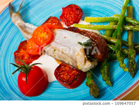 Baked whiting with sun-dried tomatoes, sparrowgrass, garlic creamy sauce Baked whiting with sun-dried tomatoes, sparrowgrass, garlic creamy sauce 109647057