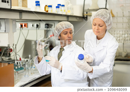 Two lab technicians working in research laboratory Two lab technicians working in research laboratory 109648099